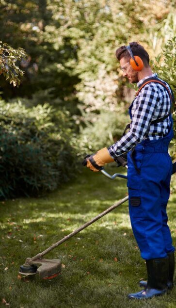 busy_man_using_weedwacker_garden